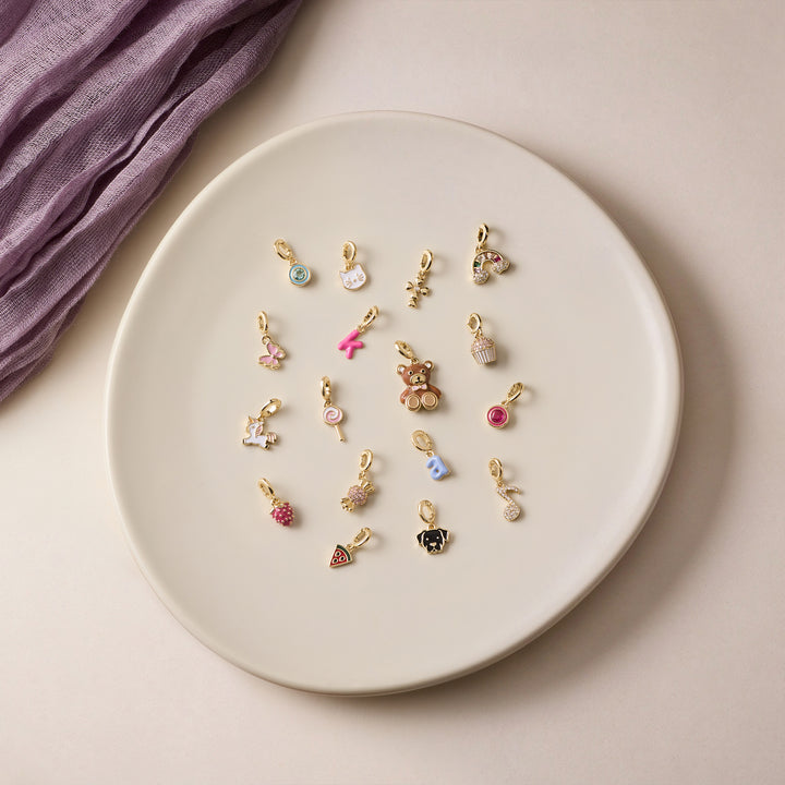 plate with a variety of kid charms for necklace.