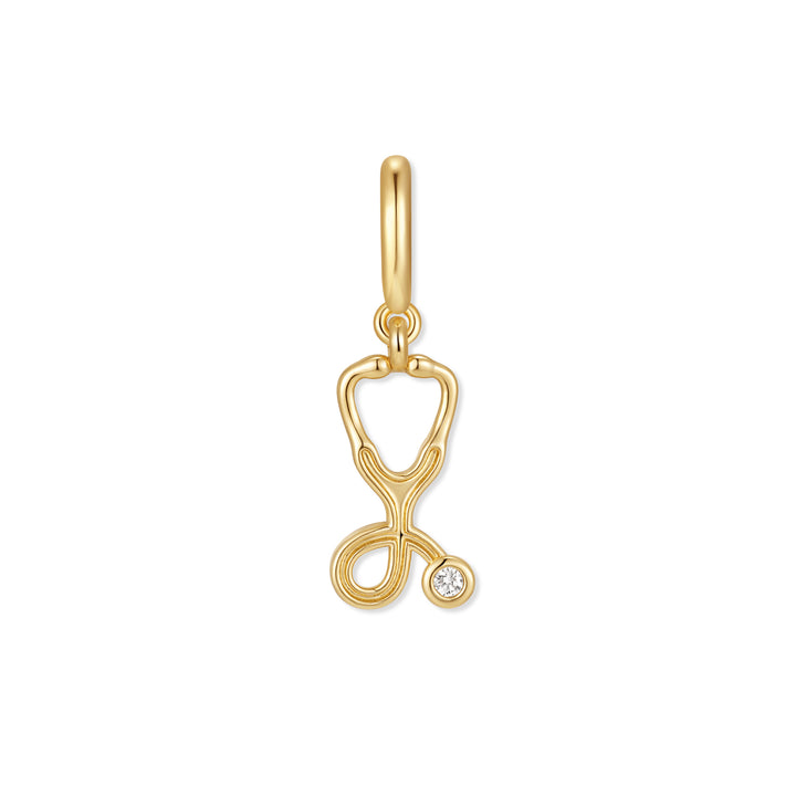 Gold-tone stethoscope charm with a bezel-set round diamond accent and a polished ring clasp at the top.