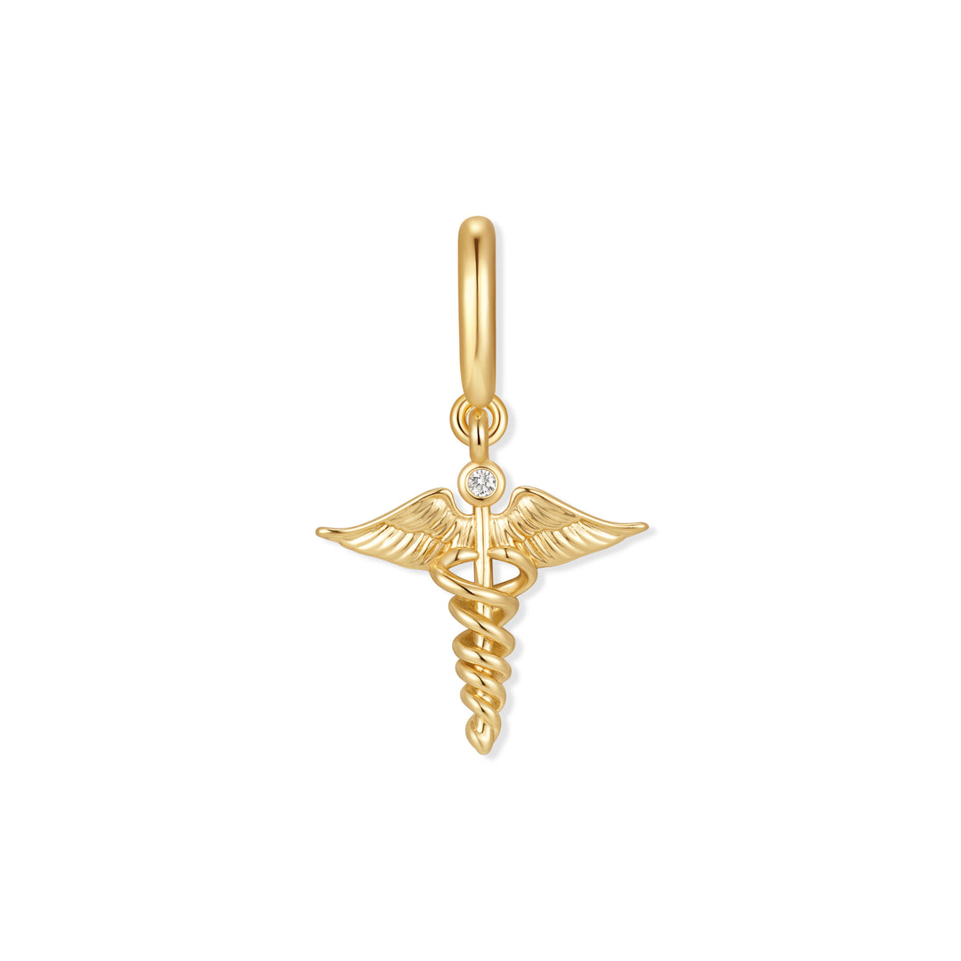 Gold-tone caduceus charm with winged staff, intertwined serpents, and a single bezel-set round diamond accent, hanging from a ring clasp.