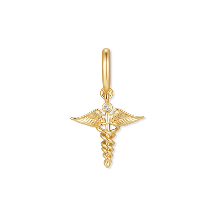 Gold-tone caduceus charm with winged staff, intertwined serpents, and a single bezel-set round diamond accent, hanging from a ring clasp.