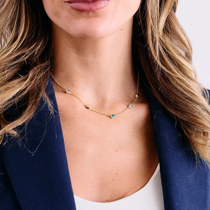 gold rolo chain with floating bezel set birthstones.