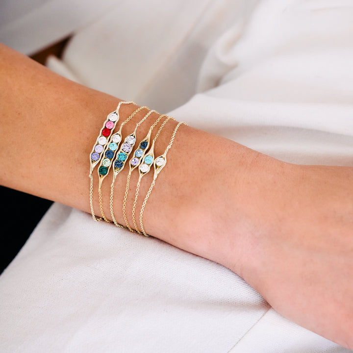 gold rolo chain bracelet with gold pea pod with birthstones.