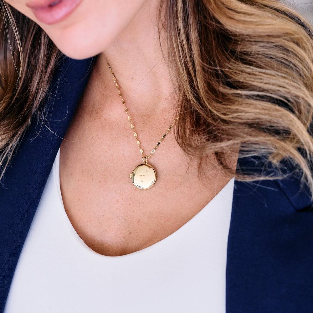 gold mirror chain with cross locket.