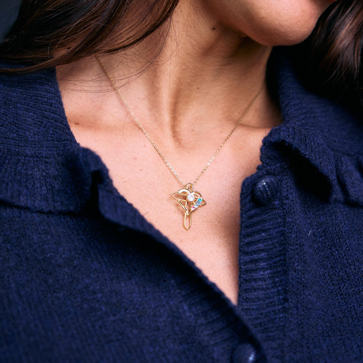 Birthstone Heart and Cross Necklace with an open heart pendant and round birthstones on a chain, worn by a model