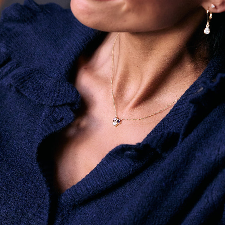 Birthstone Heart Love Necklace with four heart-cut multicolor stones in a clover-like cluster pendant, worn by a model.