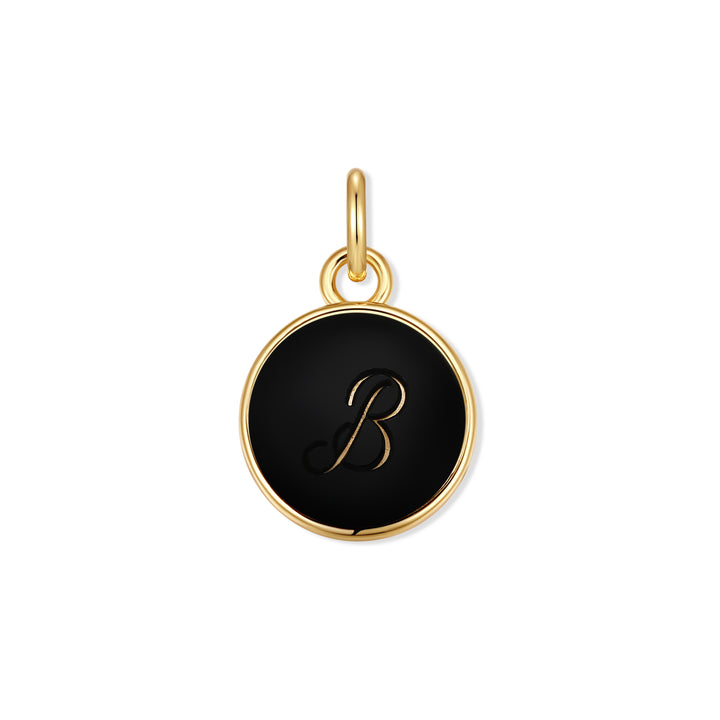 Round gold-tone initial charm with a black disc engraved with a script letter initial.